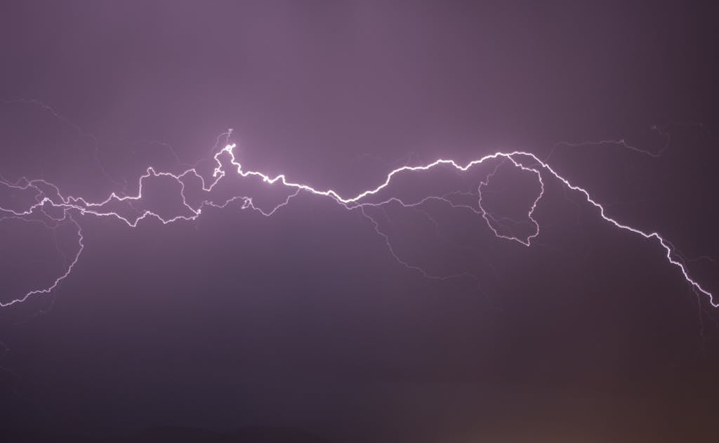 Red Lightning Flashing on Black Sky